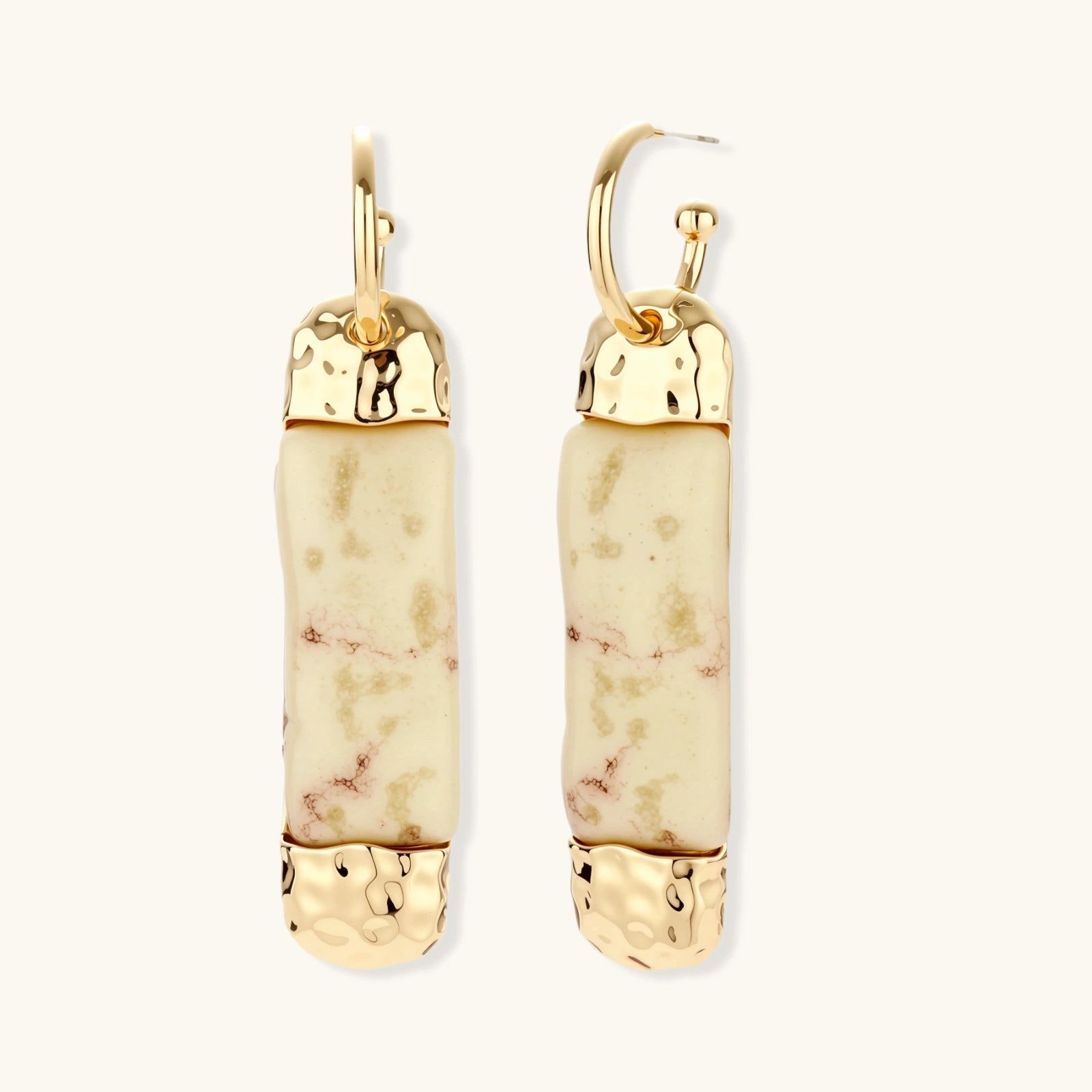 Cylindrical bar earrings featuring speckled natural resin center with polished metal caps and lever-back closures