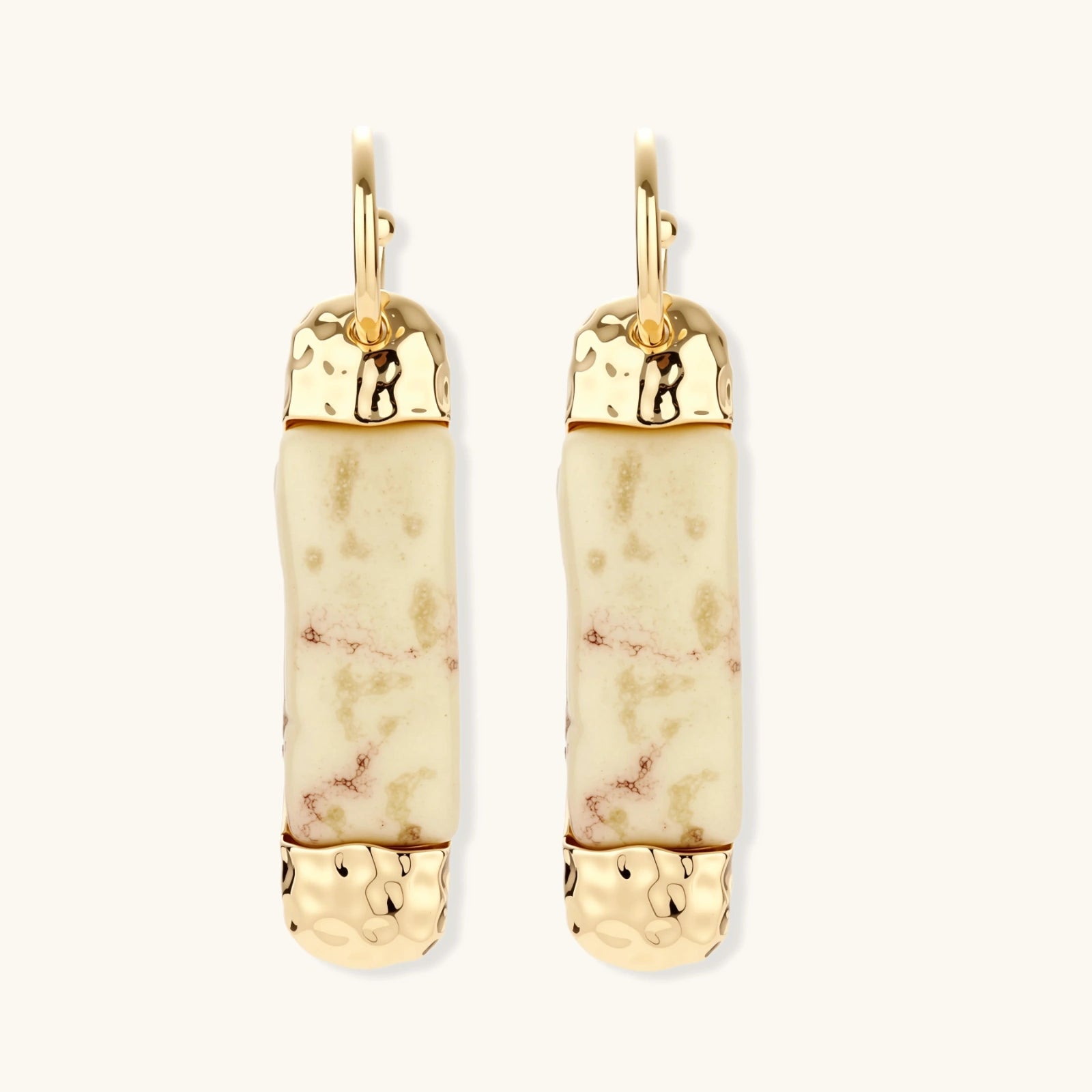 Cylindrical bar earrings featuring speckled natural resin center with polished metal caps and lever-back closures