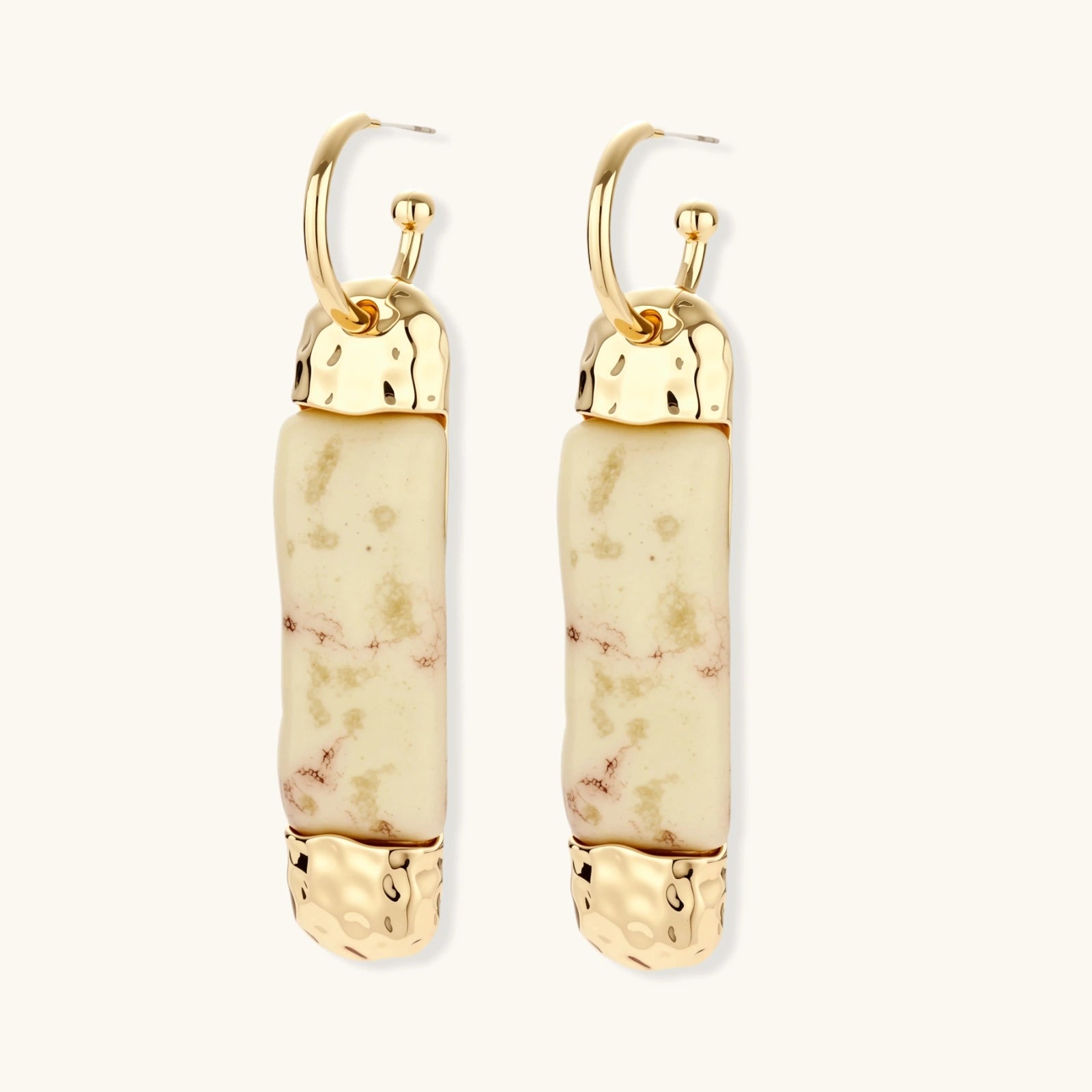 Cylindrical bar earrings featuring speckled natural resin center with polished metal caps and lever-back closures