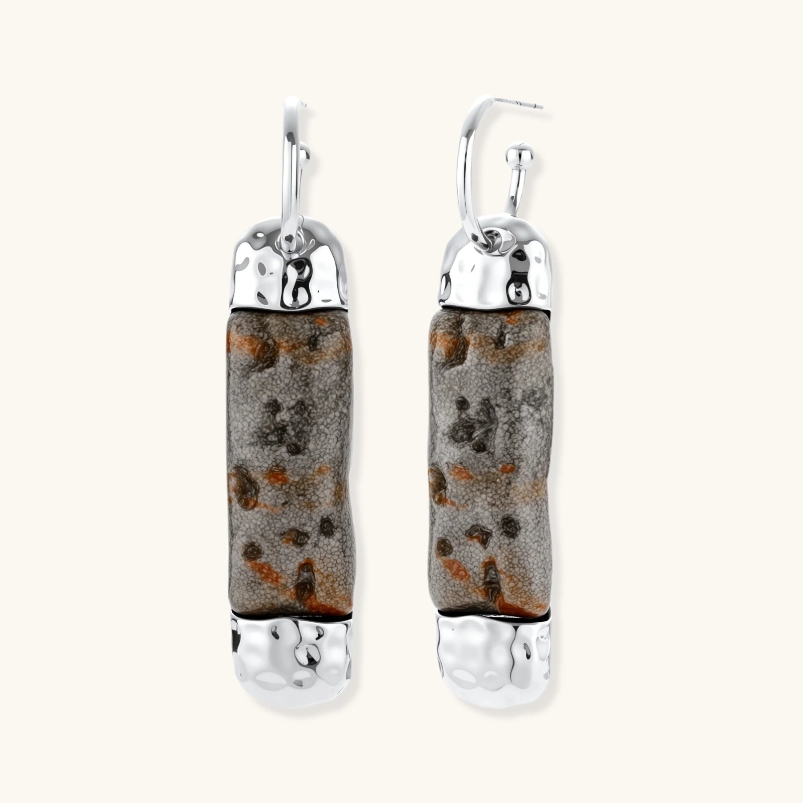 Cylindrical resin earrings with gray stone-like patterns and silver-toned metal caps, hanging against white background